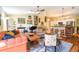 Inviting living room with hardwood floors, sofa, and a view of the kitchen's breakfast bar at 5769 E Price Blvd, North Port, FL 34288