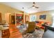 Open-concept living room with hardwood floors, built-in shelving, and a ceiling fan provides comfortable seating at 5769 E Price Blvd, North Port, FL 34288