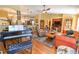 Spacious living room featuring hardwood floors, a cozy sitting area, and a piano for entertainment at 5769 E Price Blvd, North Port, FL 34288