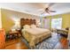 Spacious main bedroom features hardwood floors, ceiling fan, sitting area and ensuite bathroom access at 5769 E Price Blvd, North Port, FL 34288