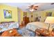 Spacious main bedroom with ceiling fan, hardwood floors, and a comfortable seating area at 5769 E Price Blvd, North Port, FL 34288