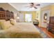 Bright main bedroom with hardwood floors, ceiling fan, sitting area, and ensuite bathroom access at 5769 E Price Blvd, North Port, FL 34288