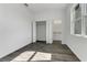 Bright bedroom with closet and bathroom access; features a modern window and gray wood floors at 3664 Ribera Ave, North Port, FL 34286