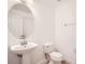 Elegant bathroom featuring a pedestal sink, an oval mirror, and tiled flooring at 6160 Castleton Hollow Rd, Riverview, FL 33578