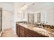 Bathroom featuring double sinks, granite countertops, and modern lighting fixtures at 6160 Castleton Hollow Rd, Riverview, FL 33578