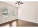 Spacious bedroom featuring beautiful hardwood floors and natural light from two windows at 6160 Castleton Hollow Rd, Riverview, FL 33578
