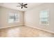 Bright and airy bedroom with tile flooring and natural light from two windows at 6160 Castleton Hollow Rd, Riverview, FL 33578