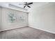 Spacious bedroom with tray ceiling, ceiling fan, and two large windows at 6160 Castleton Hollow Rd, Riverview, FL 33578