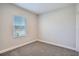 Cozy bedroom with carpet, large window, and bright neutral paint at 6160 Castleton Hollow Rd, Riverview, FL 33578