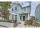 Charming blue two-story home with a white picket fence and well-maintained landscaping at 6160 Castleton Hollow Rd, Riverview, FL 33578