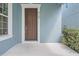 Light blue house with a dark front door and a bright white porch at 6160 Castleton Hollow Rd, Riverview, FL 33578