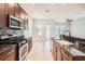 Kitchen with stainless steel appliances, granite countertops, and views of the living area at 6160 Castleton Hollow Rd, Riverview, FL 33578