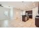 Open-concept living space with tile floors, recessed lighting, and a view into the modern kitchen at 6160 Castleton Hollow Rd, Riverview, FL 33578