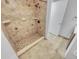 Bathroom with tiled walk-in shower, tiled floors, and natural light at 557 Pinellas Bayway S # 111, St Petersburg, FL 33715