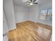 Bright bedroom with ceiling fan, wood floors, and a large window with shutters at 557 Pinellas Bayway S # 111, St Petersburg, FL 33715