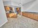 Kitchen with island and abundant counterspace, featuring wood cabinets and tile floors at 557 Pinellas Bayway S # 111, St Petersburg, FL 33715
