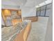 Kitchen featuring granite countertops, tile backsplash, and stainless steel appliances at 557 Pinellas Bayway S # 111, St Petersburg, FL 33715