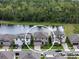 Aerial view of a property showcasing the surrounding neighborhood and a nearby pond at 12654 Oak Hill Way, Parrish, FL 34219