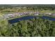 An aerial view shows the homes in the community surrounding a beautiful pond at 12654 Oak Hill Way, Parrish, FL 34219