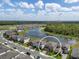 Aerial view of a house showcasing a pond and surroundings with other houses at 12654 Oak Hill Way, Parrish, FL 34219