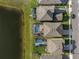 An aerial view of homes with screened-in pools near a tranquil lake, showcasing community living at 12654 Oak Hill Way, Parrish, FL 34219
