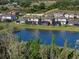An aerial view showcases the serene lake and the backyards of the houses at 12654 Oak Hill Way, Parrish, FL 34219