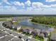 An aerial view showcases the neighborhood and the proximity to the large lake at 12654 Oak Hill Way, Parrish, FL 34219