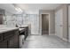 A bright bathroom with marble tile floors, a double sink vanity, and a glass-enclosed shower at 12654 Oak Hill Way, Parrish, FL 34219