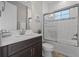 Bathroom features a shower, tub combo with glass doors, and granite countertop vanity at 12654 Oak Hill Way, Parrish, FL 34219