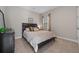 Cozy bedroom featuring neutral tones, carpet, and a large window at 12654 Oak Hill Way, Parrish, FL 34219