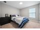 Cozy bedroom featuring a comfortable bed, dresser, and a large window at 12654 Oak Hill Way, Parrish, FL 34219