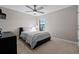 Neutral bedroom with ceiling fan, large window and carpeted flooring at 12654 Oak Hill Way, Parrish, FL 34219