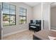 Cozy den featuring two bright windows, a piano, and wood-look tile flooring at 12654 Oak Hill Way, Parrish, FL 34219