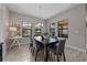 Elegant dining room with a dark wood table, six chairs, and large windows overlooking the backyard at 12654 Oak Hill Way, Parrish, FL 34219