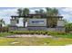 A close view of the Crosswind Point entrance sign with rocks and plants at 12654 Oak Hill Way, Parrish, FL 34219