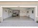 Spacious three-car garage with epoxy flooring, car, and wall decor at 12654 Oak Hill Way, Parrish, FL 34219