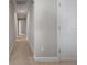 Long hallway with neutral paint and carpet, and doors leading to various rooms at 12654 Oak Hill Way, Parrish, FL 34219