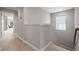 Hallway features neutral walls, plush carpet, and natural light from a nearby window at 12654 Oak Hill Way, Parrish, FL 34219