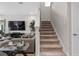 Living room with staircase and contemporary furniture, creating a welcoming atmosphere at 12654 Oak Hill Way, Parrish, FL 34219