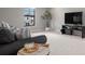 Bright living room with modern decor, a large window, and stylish furnishings at 12654 Oak Hill Way, Parrish, FL 34219