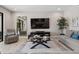 Inviting living room with neutral tones, modern decor, and a view into other rooms at 12654 Oak Hill Way, Parrish, FL 34219