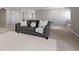 Spacious living room featuring a comfortable sofa, neutral tones, and plush carpeting at 12654 Oak Hill Way, Parrish, FL 34219