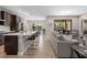 Open-concept living space with sleek kitchen island, dining area, and comfortable living room, seamlessly connected at 12654 Oak Hill Way, Parrish, FL 34219
