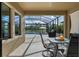 Screened patio with table, chairs, and view of pool and lake at 12654 Oak Hill Way, Parrish, FL 34219