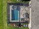 Aerial view of a screened-in pool with patio furniture and an outdoor kitchen area at 12654 Oak Hill Way, Parrish, FL 34219