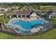 An overhead view shows a fenced community pool with lounge chairs and an outdoor pavilion at 12654 Oak Hill Way, Parrish, FL 34219