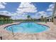 Community pool with handicap access and lounge chairs overlooking a pond at 12654 Oak Hill Way, Parrish, FL 34219