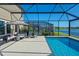 Screened-in pool with sun loungers overlooking the lake at 12654 Oak Hill Way, Parrish, FL 34219