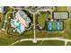 An aerial view showcasing the community pool, pickleball courts, parking, and manicured landscape of the property at 6237 Plateau Ct, Bradenton, FL 34203