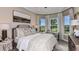 Bedroom featuring a large bed, neutral paint, decorative light fixture, and view of the exterior landscaping at 6237 Plateau Ct, Bradenton, FL 34203